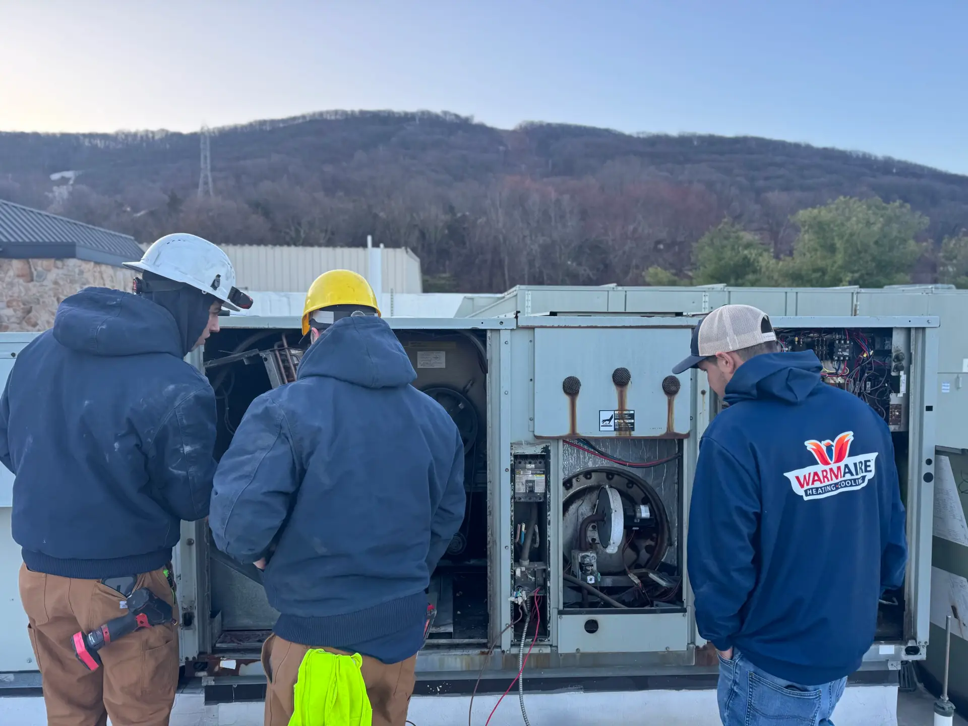 HVAC technicians performing rooftop unit maintenance