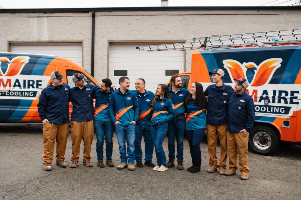 Team standing in front of company vans.