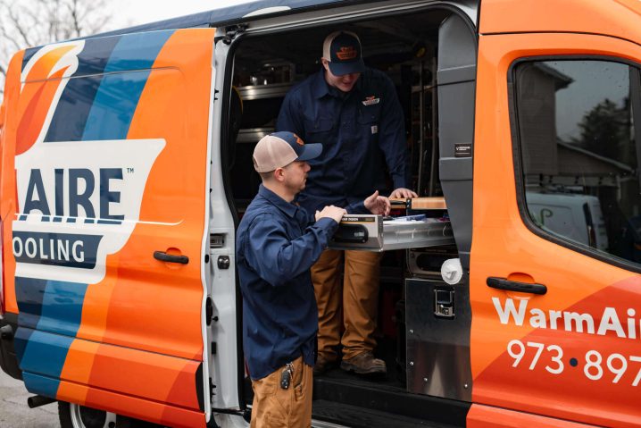 Two technicians working from service van.